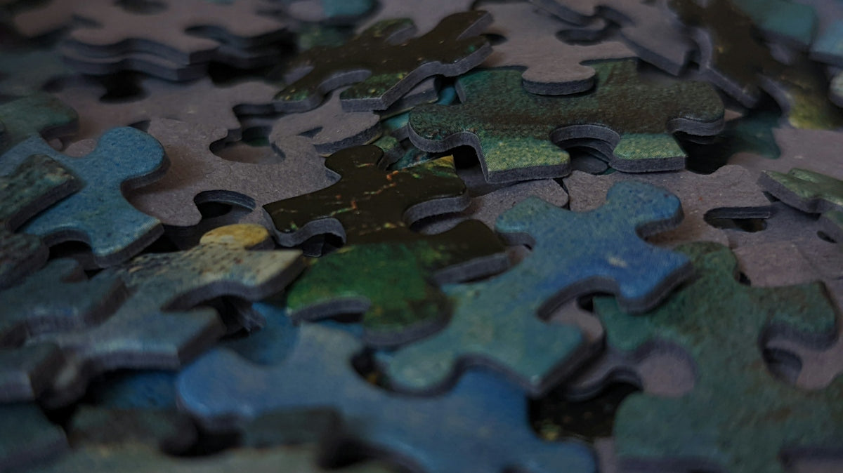 a close up of a puzzle with many pieces missing