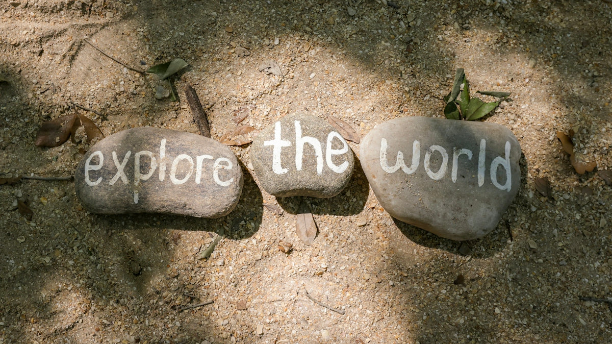 two rocks with the words explore the world written on them