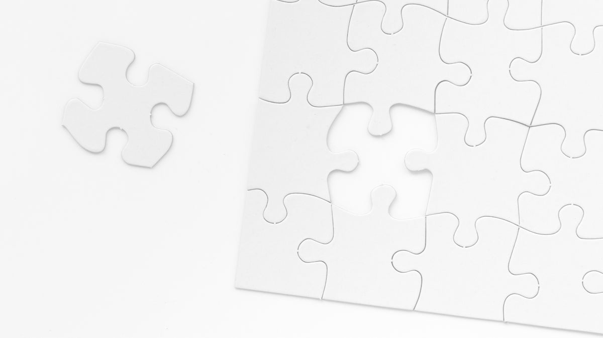 a piece of white puzzle sitting on top of a table