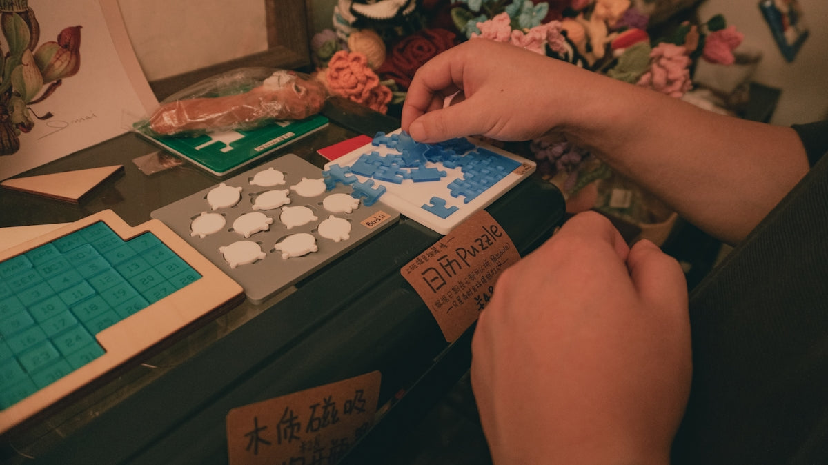 a person sitting at a table with a box of cookies