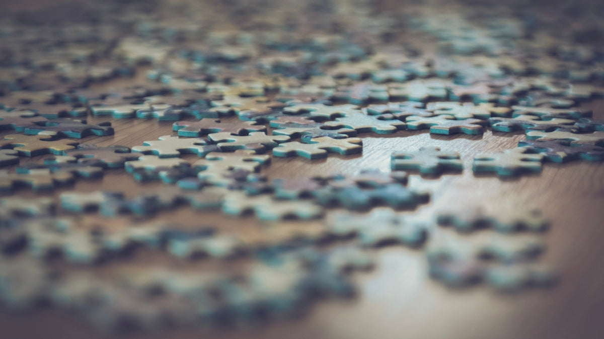 a close up of a puzzle piece on a table