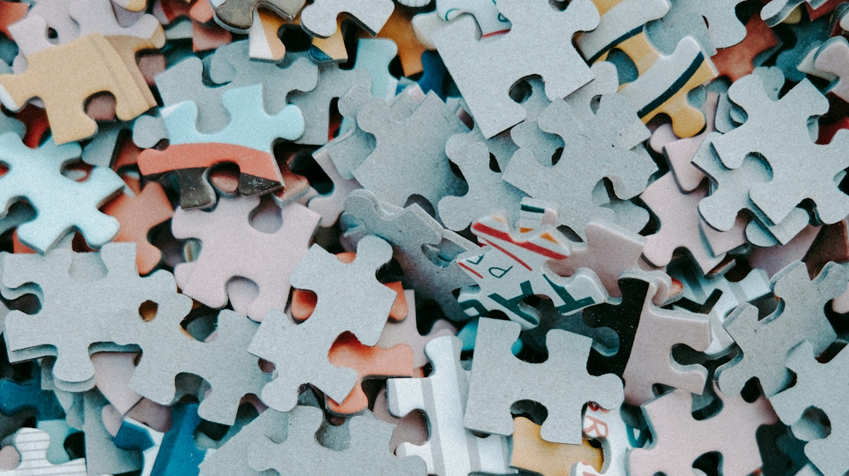 a pile of different colored puzzle pieces