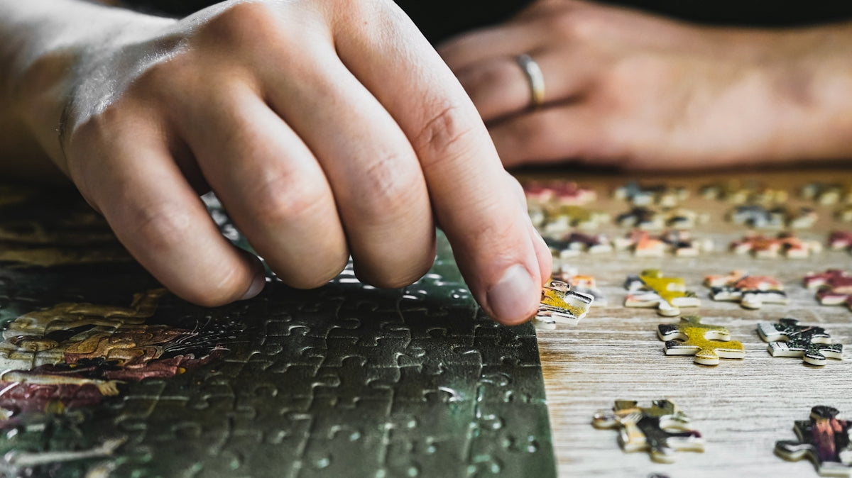 a close up of a person's hand on a puzzle