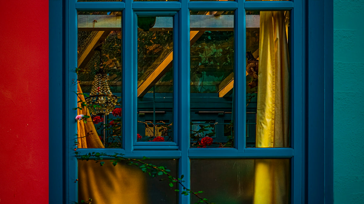 A blue window with a red wall in the background