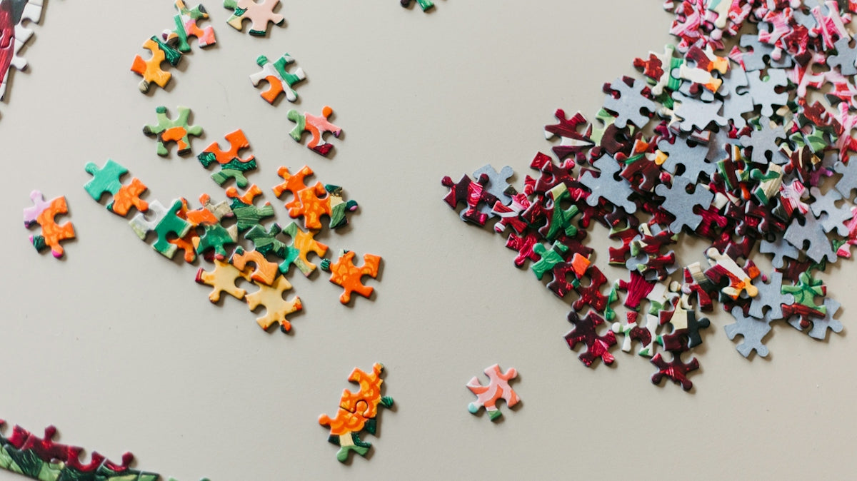 A large group of puzzle pieces on a table