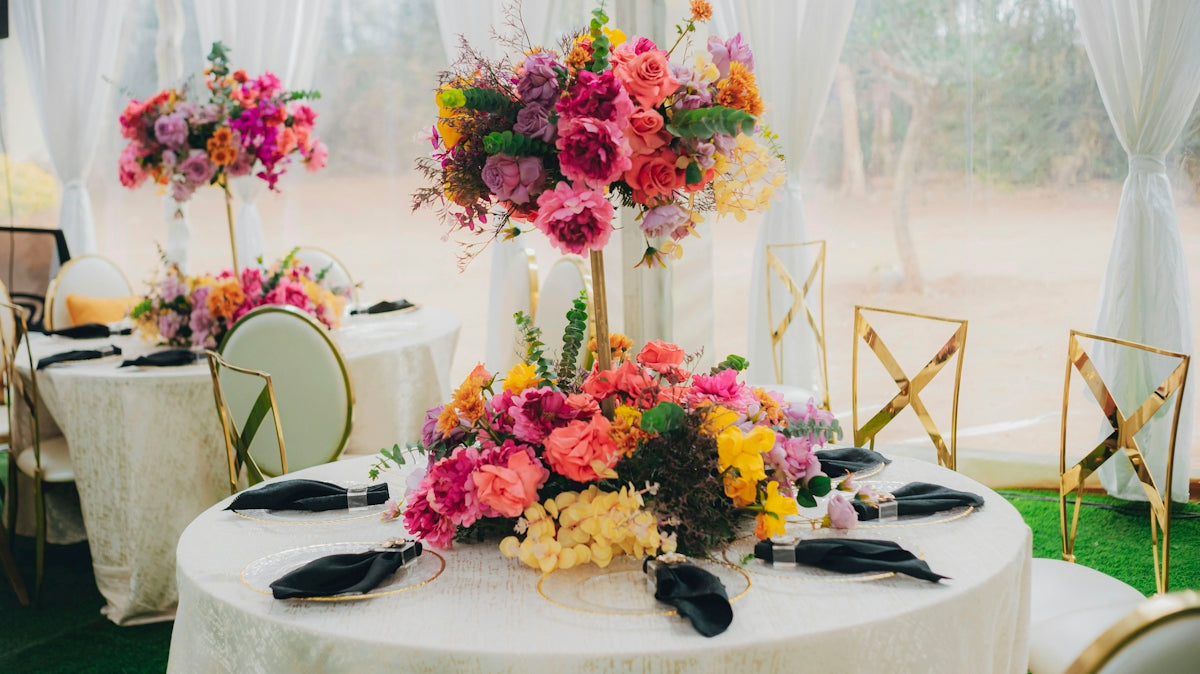 Elegant tables with vibrant floral centerpieces at an event