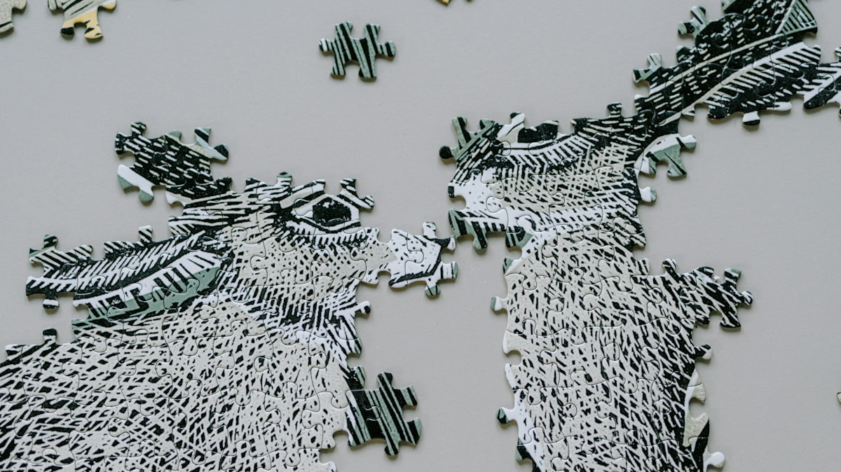 Two unfinished donkey puzzle pieces face each other