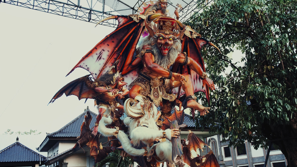 Intricate statue of mythical creatures with demonic figures.