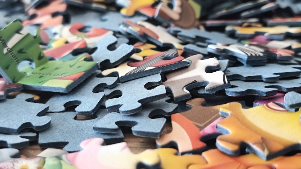 A pile of colorful puzzle pieces scattered around.