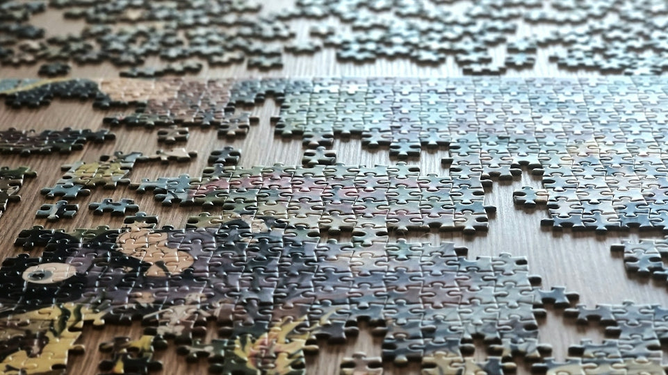 Scattered puzzle pieces on a wooden surface