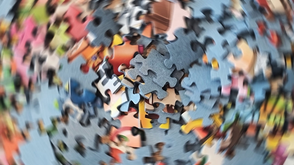Scattered colorful puzzle pieces with motion blur effect