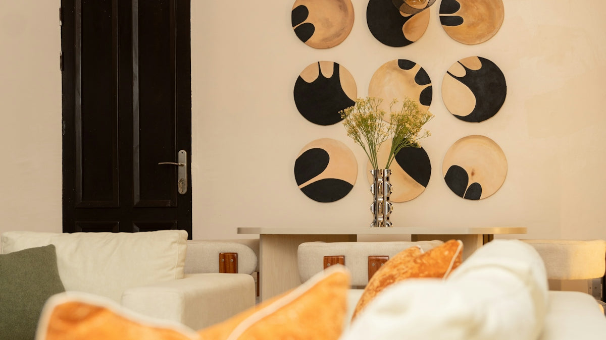 Elegant living room featuring circular wall art and modern lighting.
