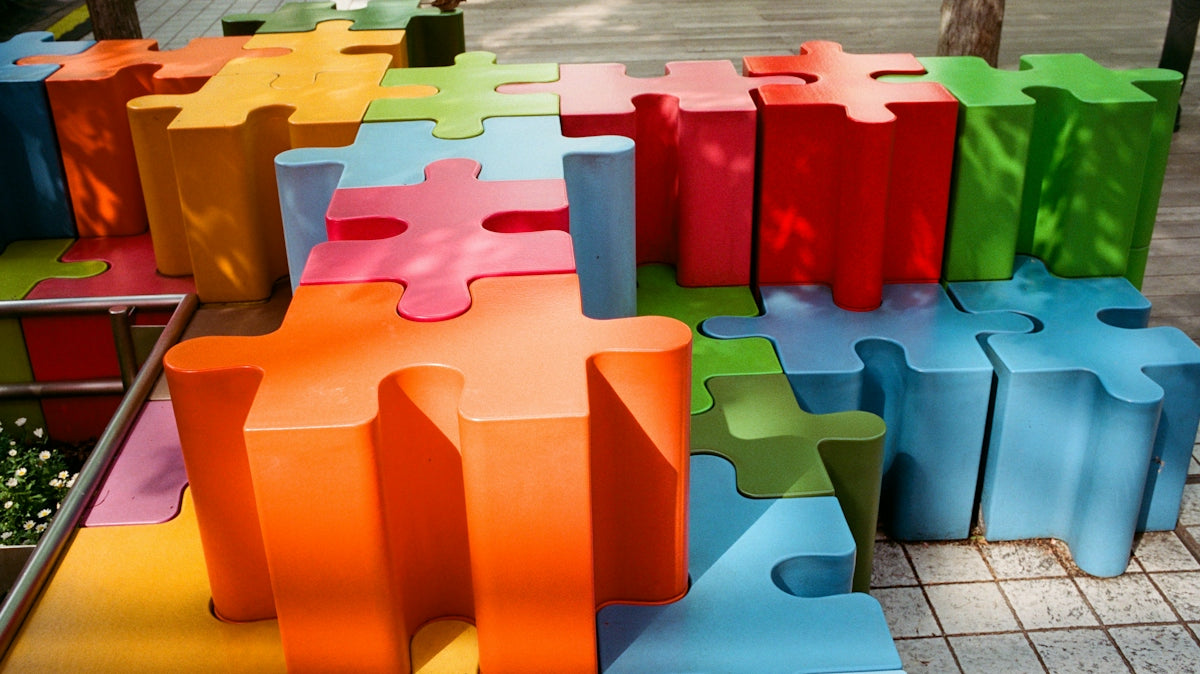 Colorful puzzle piece shaped blocks arranged outdoors