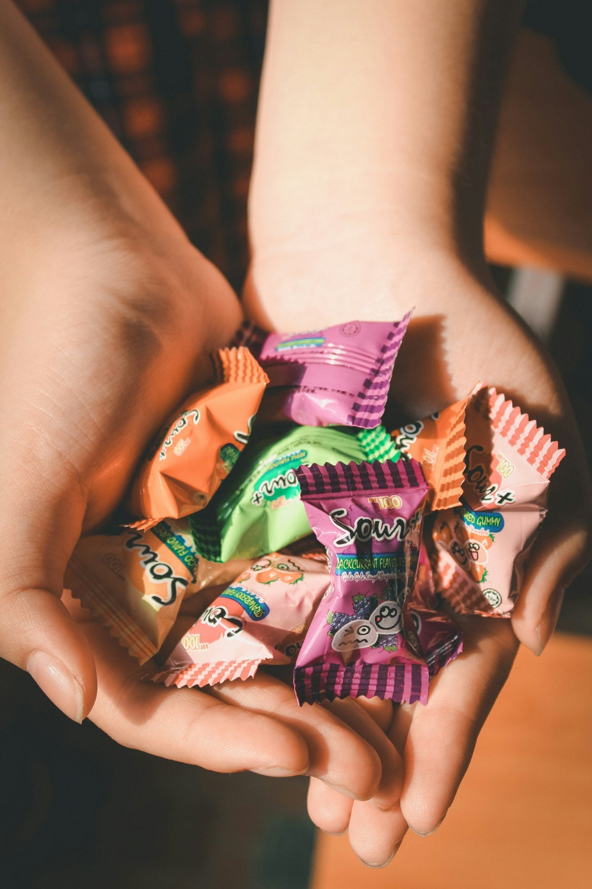 person holding packs of candy