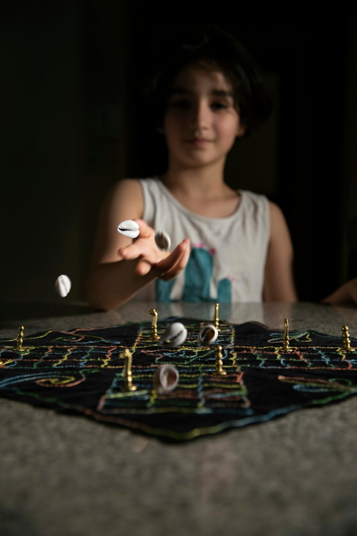 woman in teal scoop neck shirt playing chess