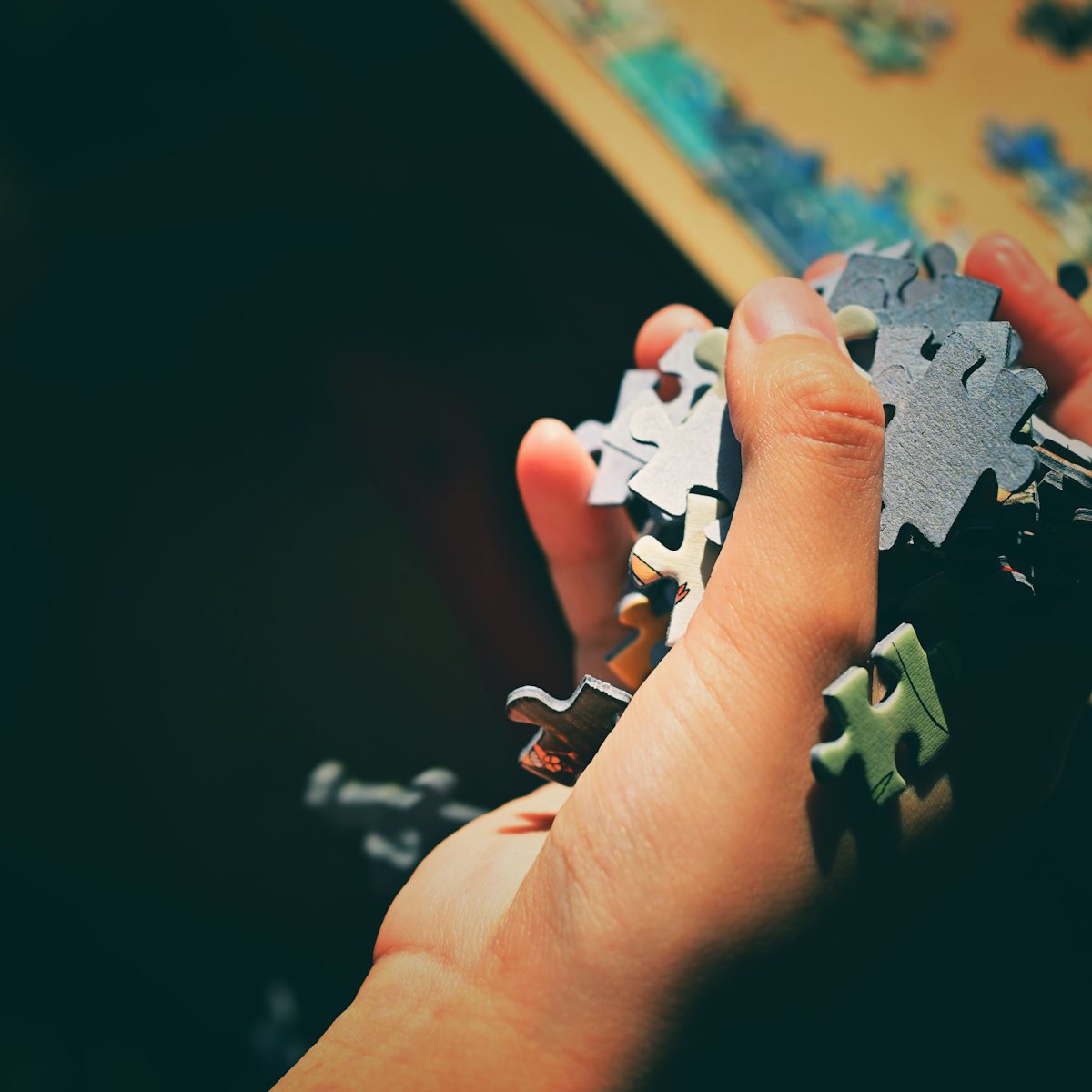 a person holding a puzzle piece in their hand