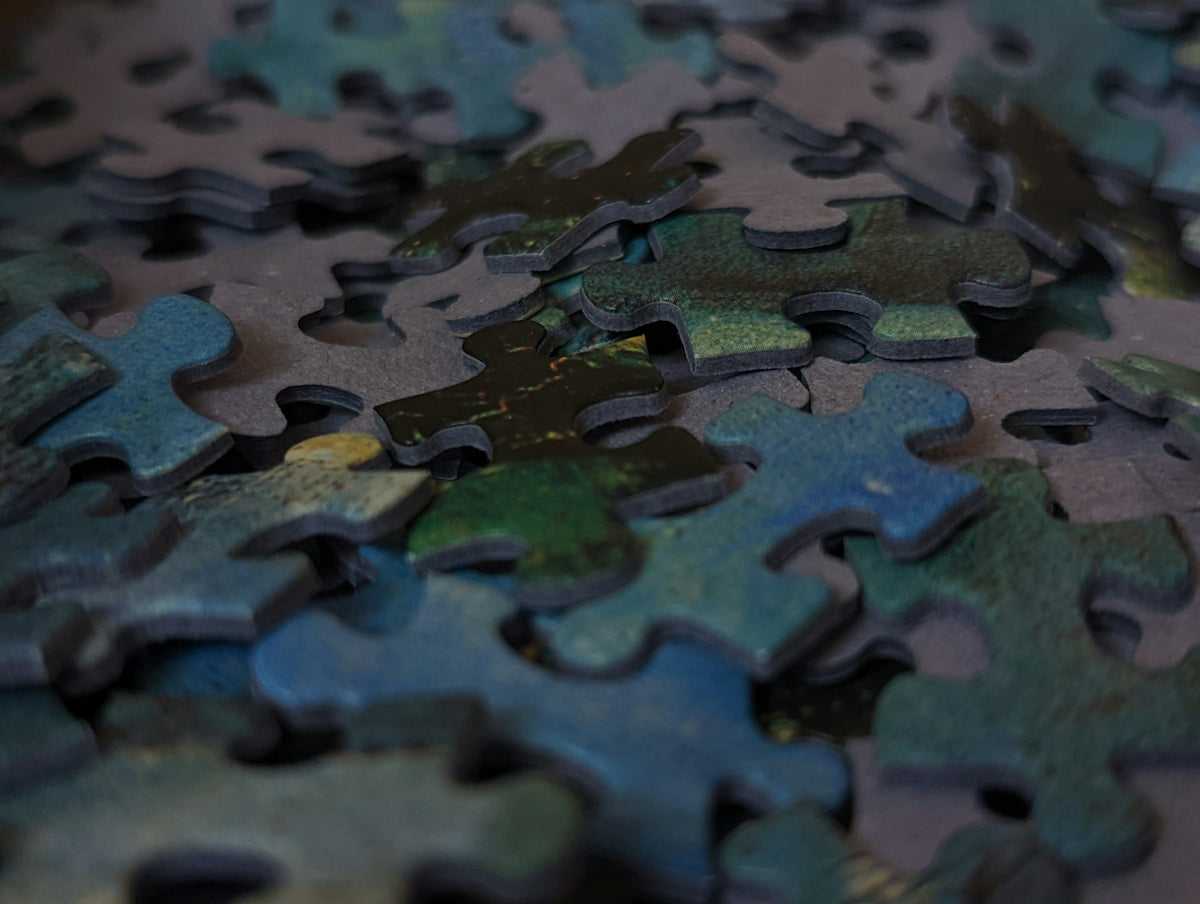 a close up of a puzzle with many pieces missing