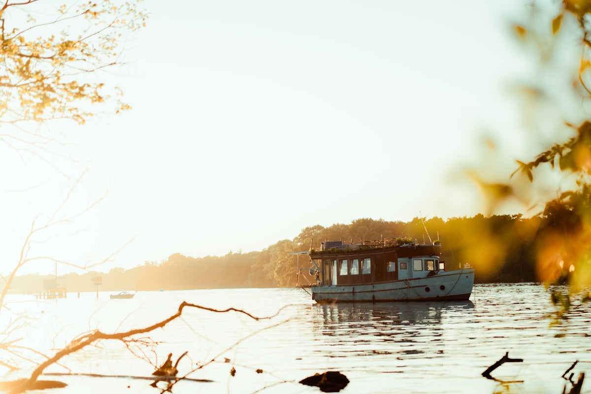 Houseboat floats serenely on the still water.