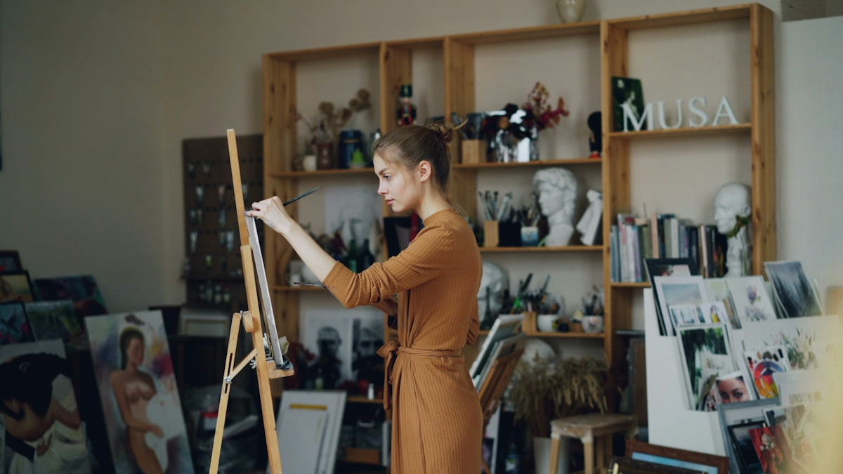 A woman paints in her artistic studio