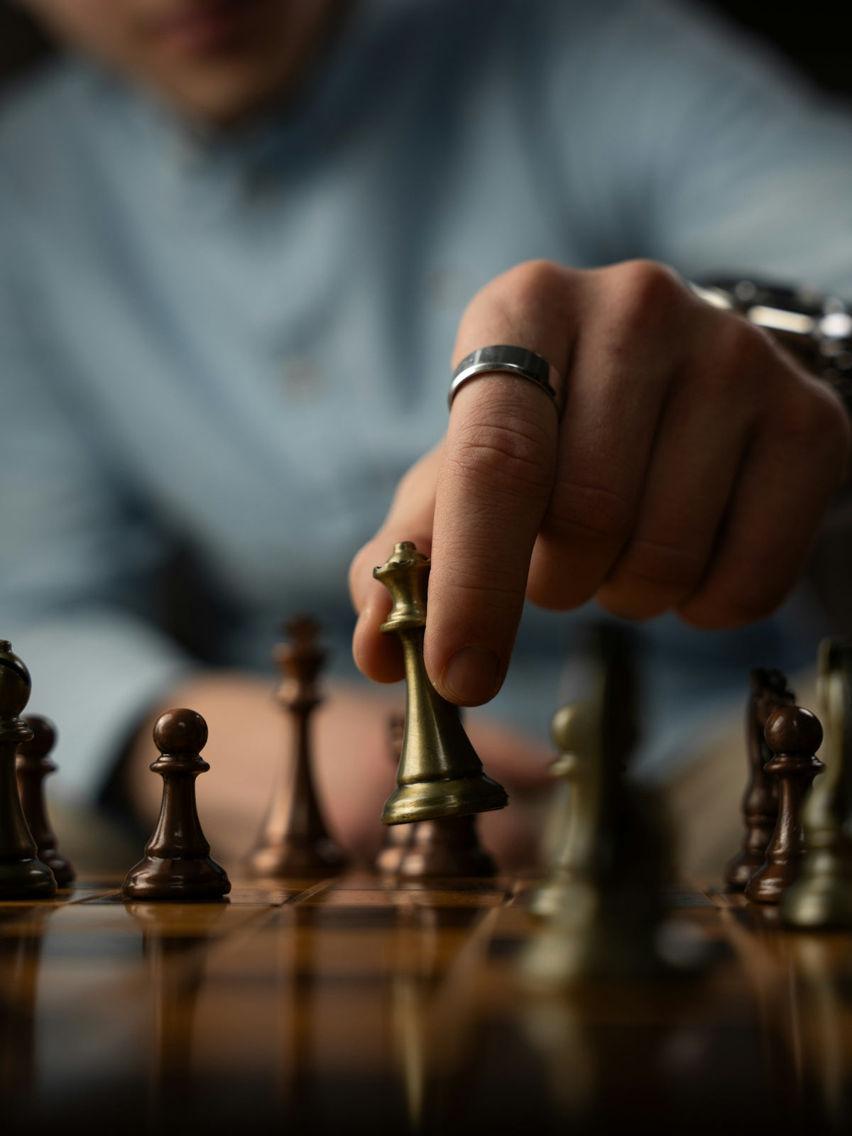 Person moving a chess piece on a board