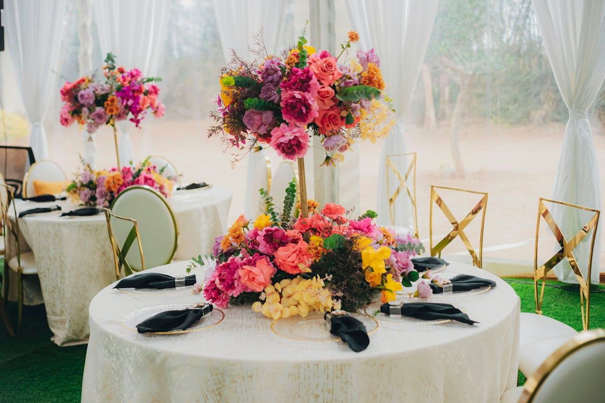 Elegant tables with vibrant floral centerpieces at an event