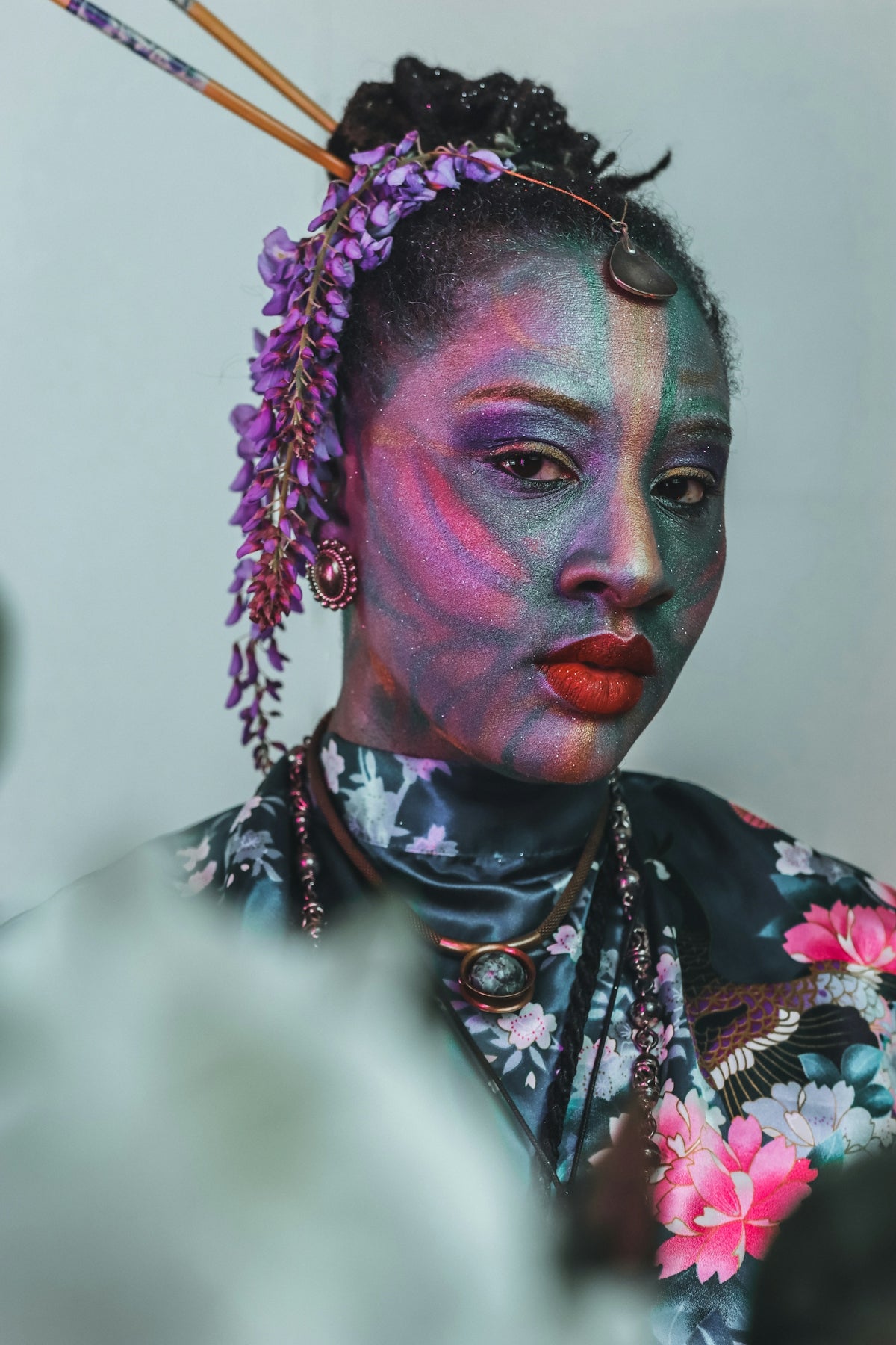 Woman with artistic face paint and floral kimono