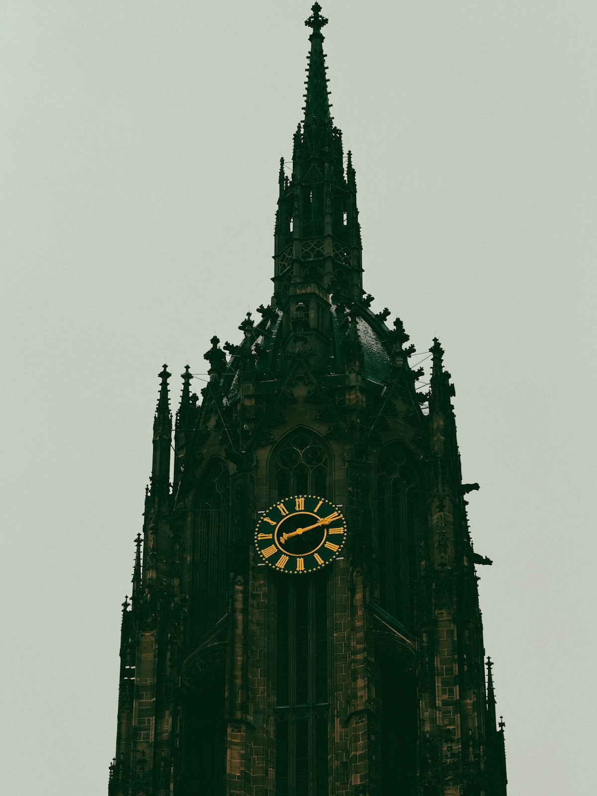 Gothic cathedral tower with a large clock