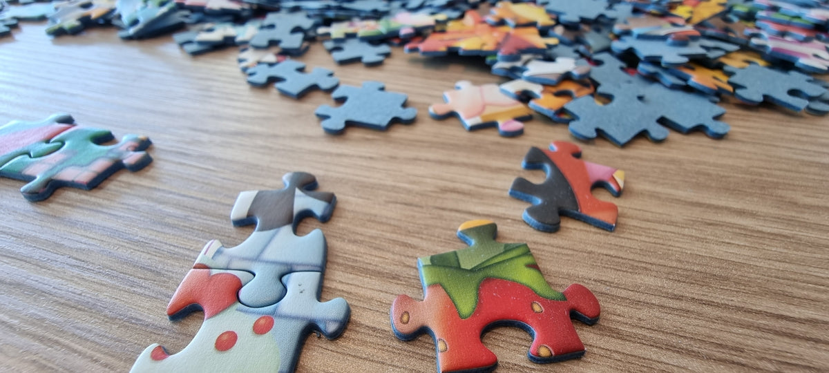 Scattered puzzle pieces on a wooden surface