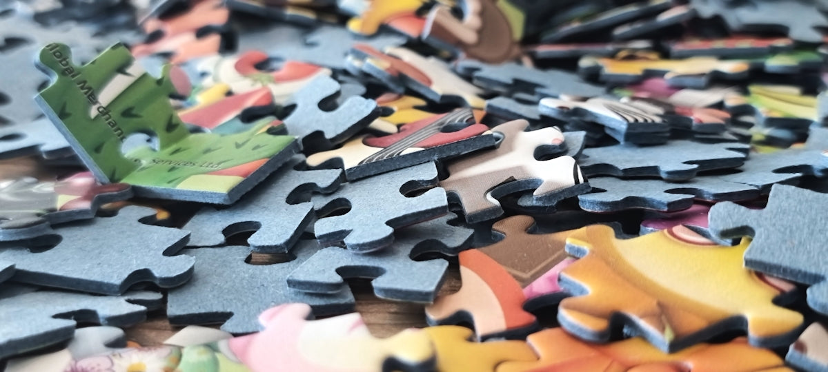 A pile of colorful puzzle pieces scattered around.