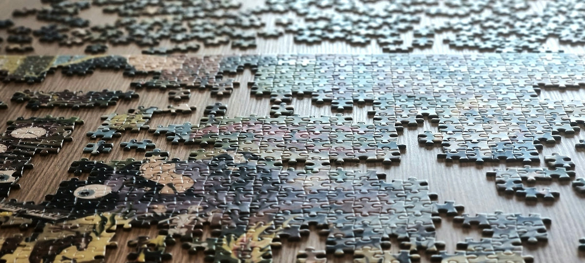 Scattered puzzle pieces on a wooden surface