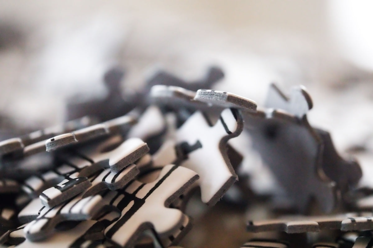 Scattered grey puzzle pieces.