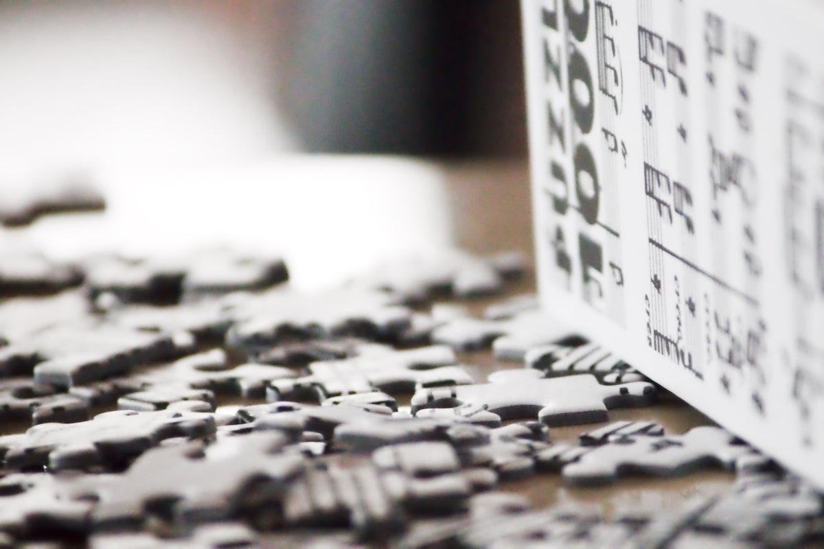 Scattered puzzle pieces and a standing puzzle box.