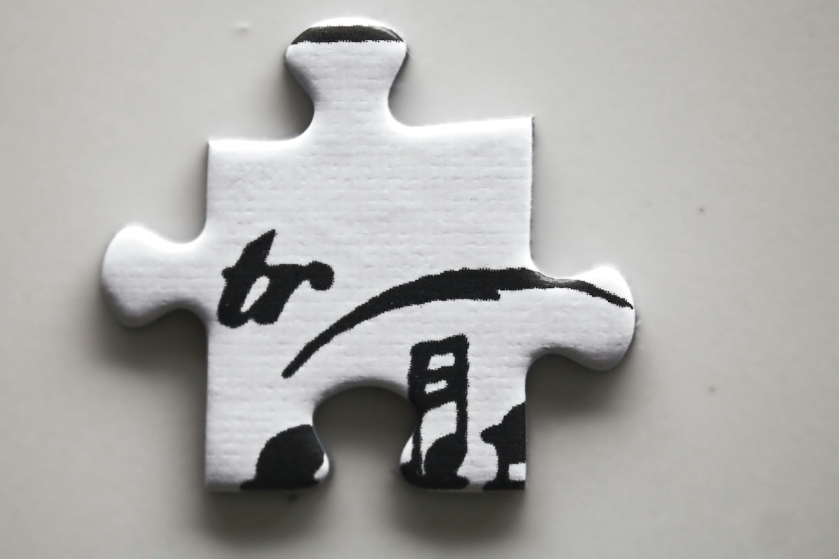 White puzzle piece with black musical notation