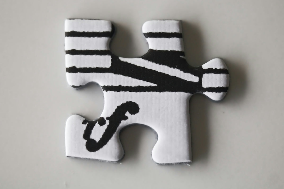 Puzzle piece with musical staff lines and a forte symbol