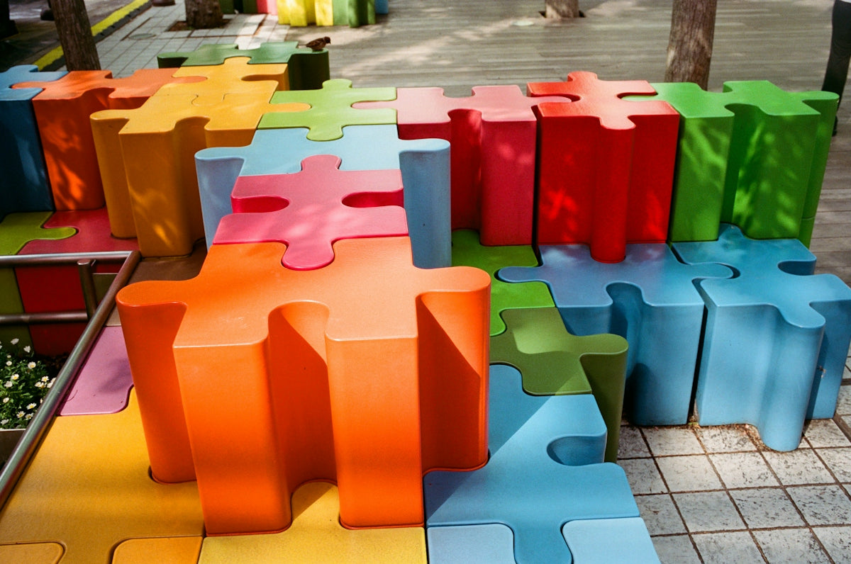Colorful puzzle piece shaped blocks arranged outdoors